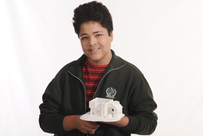 Computer student shows off their 3D print of a house.jpg