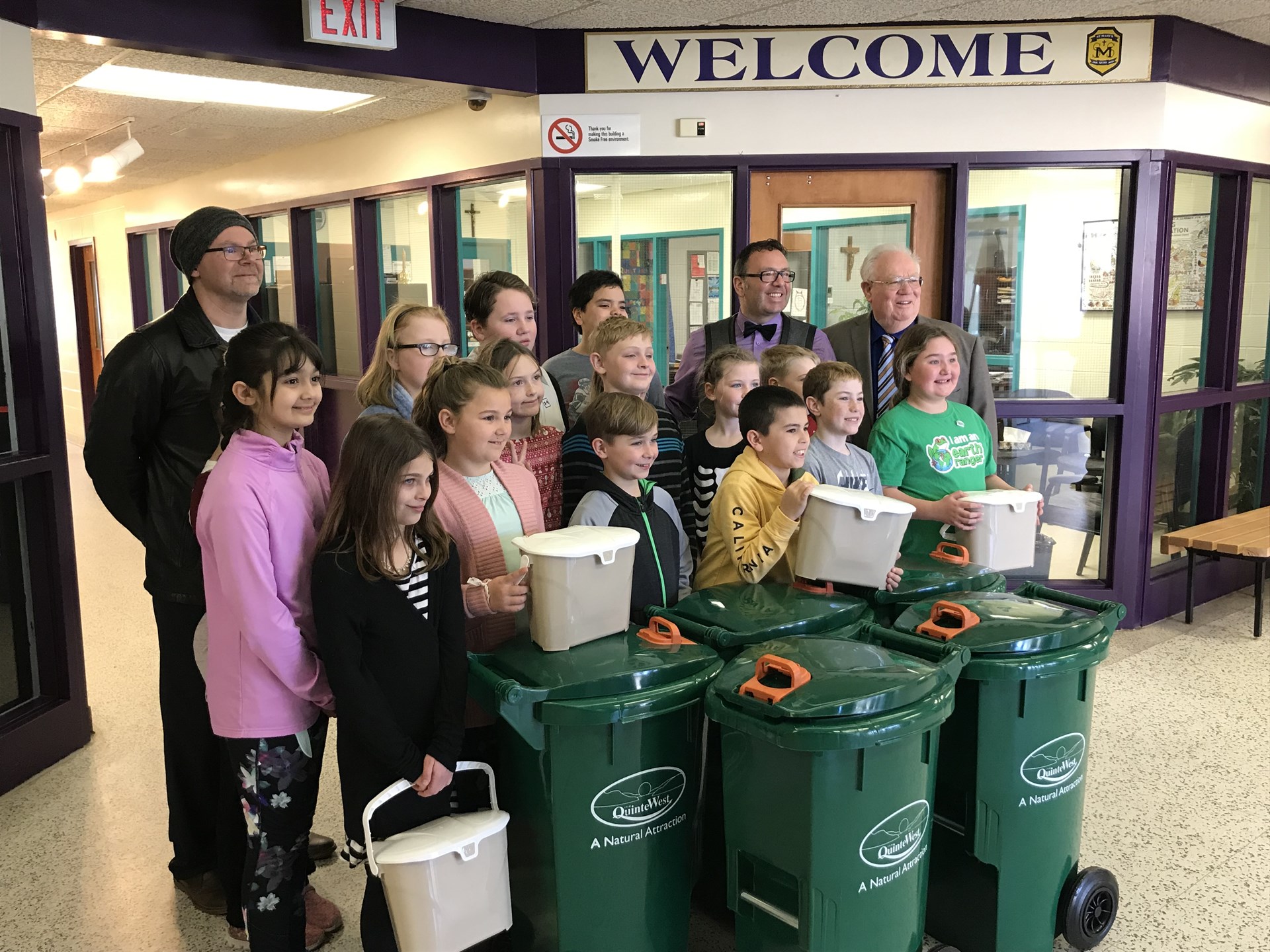Students recieving green bins from city